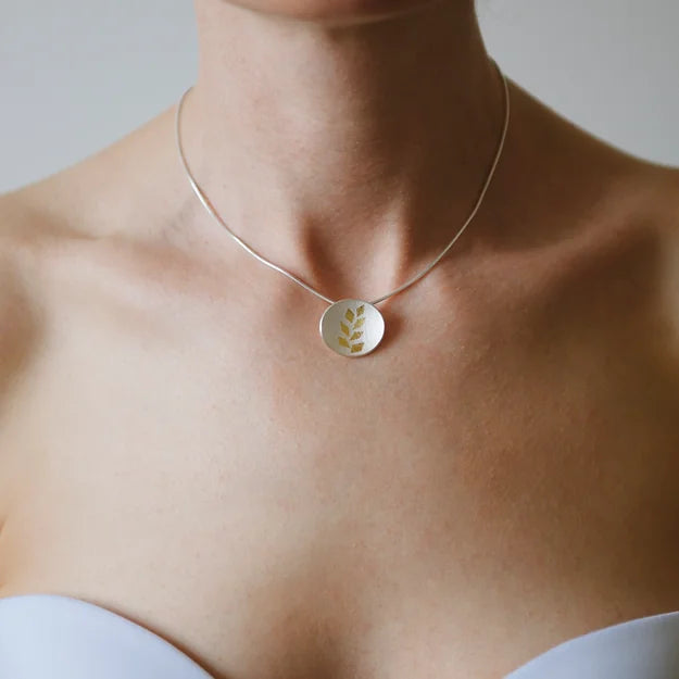 Gold Leaf Small Pendant - A curved oval sterling silver disc has been richly textured both back and front with a beautiful intricate webbed effect - 24ct gold leaf pattern on top