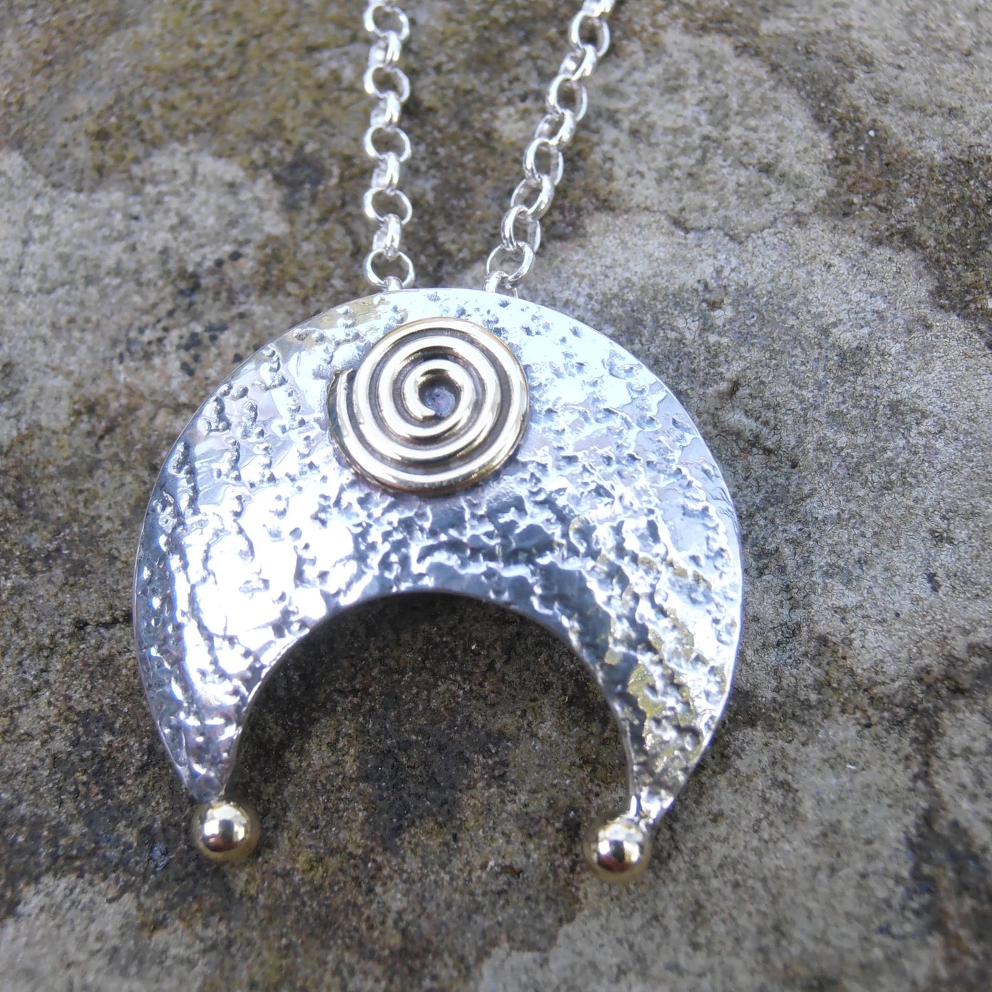 Lunula Pendant - crescent shape- two small balls of brass at each point of the crescent - brass spiral in the middle - crescent on its side - sterling silver