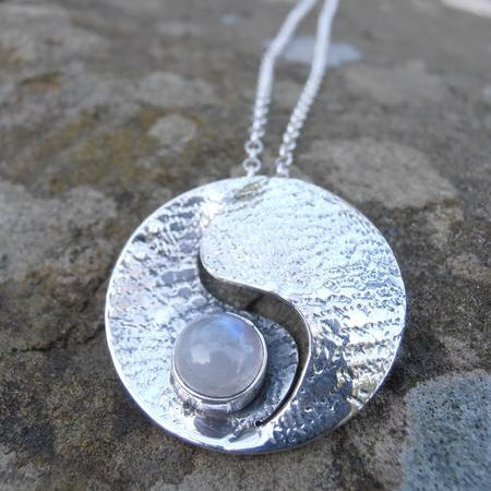 Moonstone pendant - sterling silver - moonstone in the middle - round with centre cut out.