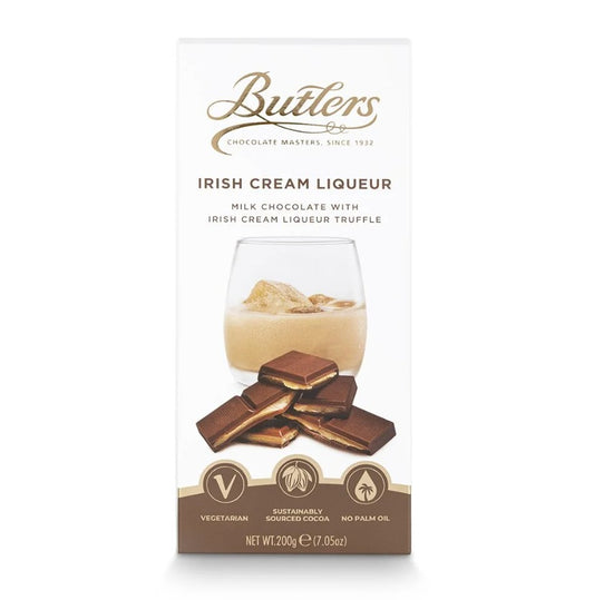 Butlers Irish Cream Liqueur chocolate bar -packaging on a white background - glass of cream liqueur - chocolate pieces
