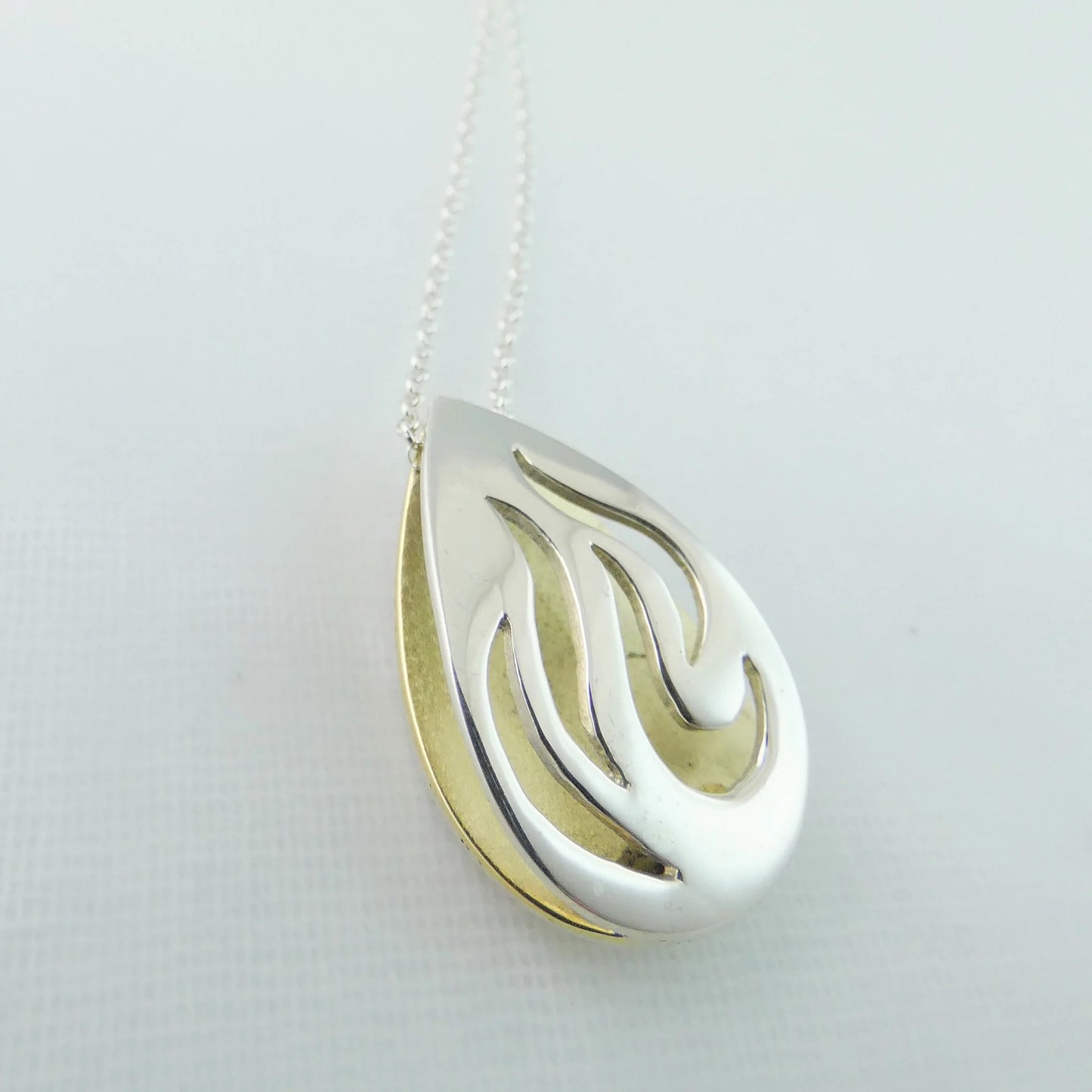  Bealtaine Pendant - shaped like the flames of fire - silver and brass - banshee silver 