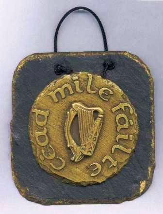 The Cead Mile Failte Wall Plaque-. This brass casting is mounted onto a slate wall hanging plaque,125mm x 125mm in size.- Cead mile Failte is an Irish greeting meaning one hundred thousand welcomes-celtic harp in the middle