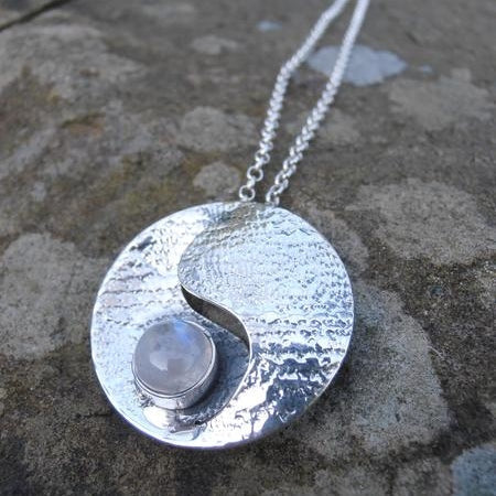 Moonstone pendant - sterling silver - moonstone in the middle - round with centre cut out.